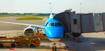 A Three Lines Group bonded transport truck receiving commercial shipments directly from a cargo airplane on the Dubai airport tarmac.